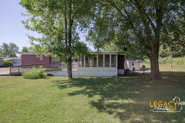 1163 Maple Leaf Ln NW, Walker, MI 49534 - view of grassy yard featuring a sunroom and a deck