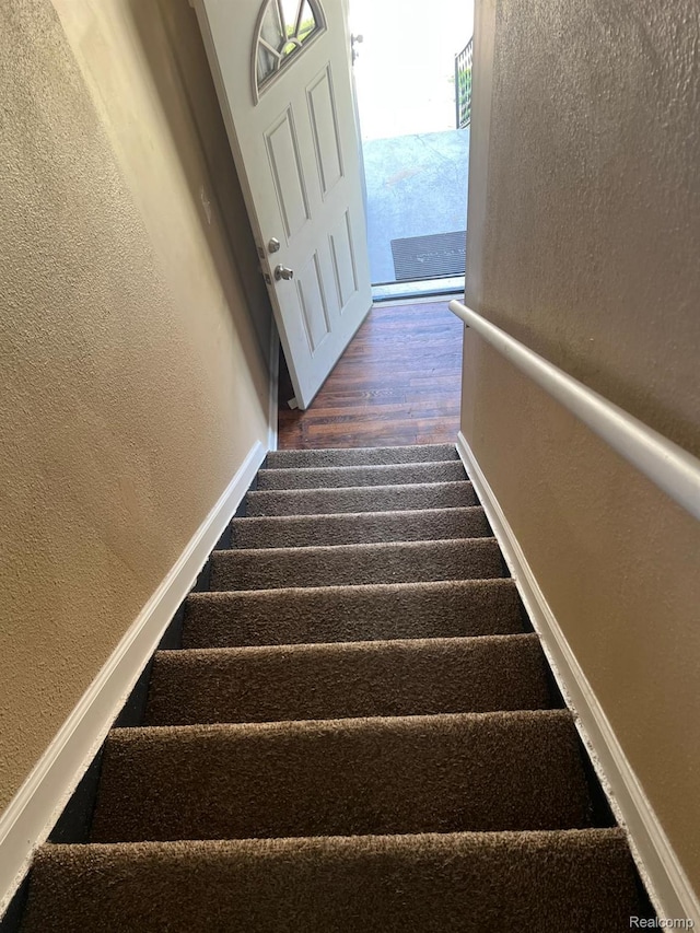 18995 Wormer St, Detroit, MI 48219 - stairway featuring a textured wall and wood finished floors