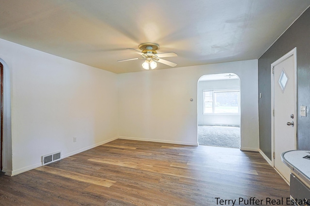1966 Roilson St, Muskegon, MI 49441 - unfurnished room featuring arched walkways, a ceiling fan, and wood finished floors