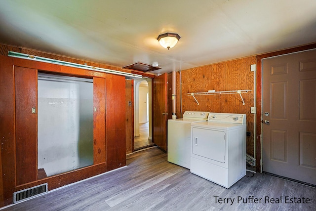 1966 Roilson St, Muskegon, MI 49441 - laundry area with washer and clothes dryer, wood finished floors, and wooden walls