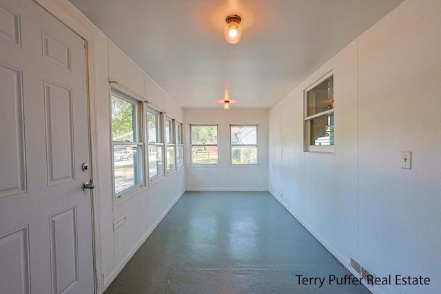 1966 Roilson St, Muskegon, MI 49441 - unfurnished sunroom with finished concrete flooring and plenty of natural light