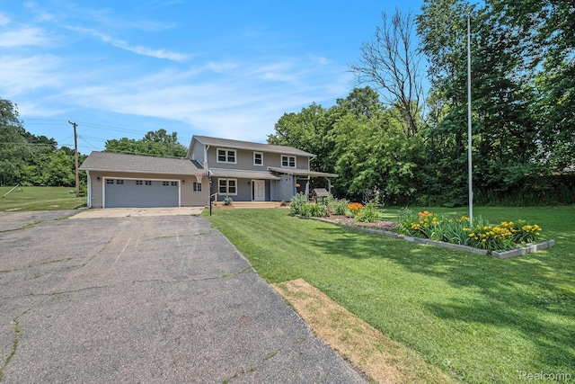 3596 Hunt Rd, Lapeer, MI 48446 - view of front of home with driveway, an attached garage, a front lawn, and covered porch
