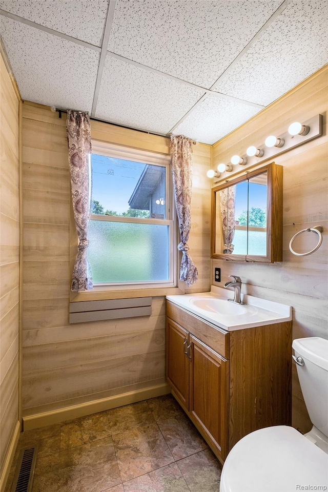 3596 Hunt Rd, Lapeer, MI 48446 - half bathroom with vanity, a paneled ceiling, and wooden walls
