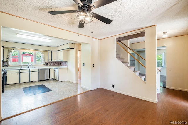3596 Hunt Rd, Lapeer, MI 48446 - kitchen featuring stainless steel dishwasher, wood finished floors, light countertops, ceiling fan, and a textured ceiling