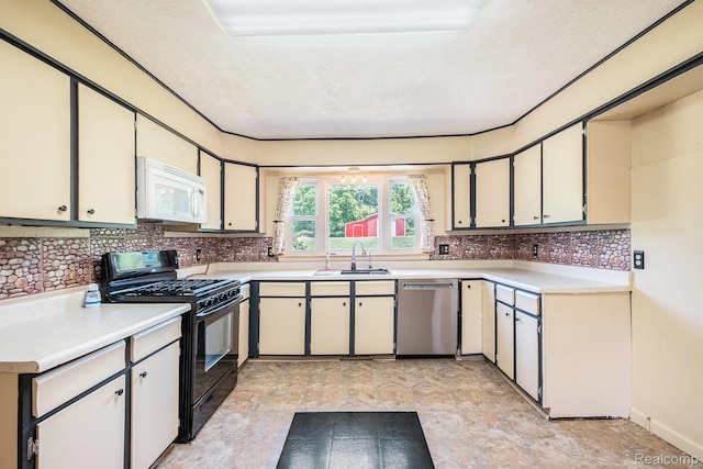 3596 Hunt Rd, Lapeer, MI 48446 - kitchen with white microwave, dishwasher, black range with gas stovetop, and backsplash
