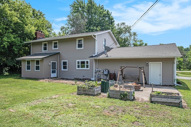 3596 Hunt Rd, Lapeer, MI 48446 - back of property with a garden, a lawn, and a chimney