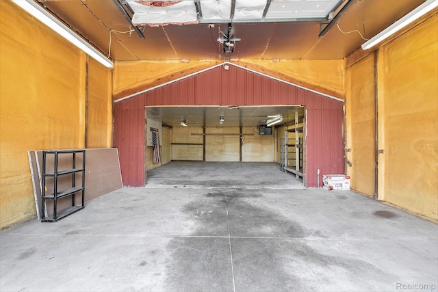 3596 Hunt Rd, Lapeer, MI 48446 - garage featuring a garage door opener and wood walls