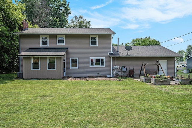 3596 Hunt Rd, Lapeer, MI 48446 - back of property with a chimney, a lawn, and a garden