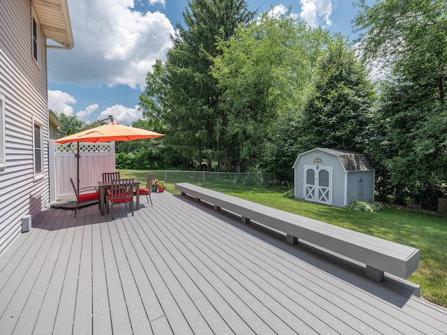 1627 Whitby Ave, Portage, MI 49024 - deck featuring a storage unit, a fenced backyard, outdoor dining area, and view of scattered trees