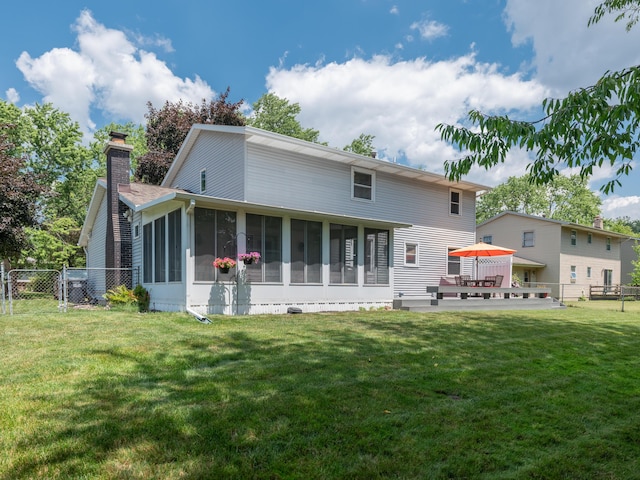 1627 Whitby Ave, Portage, MI 49024 - back of property with a sunroom, a chimney, and a gate