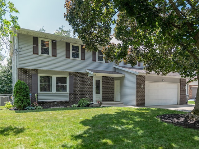 1627 Whitby Ave, Portage, MI 49024 - view of front of house featuring brick siding, concrete driveway, a front lawn, and a garage