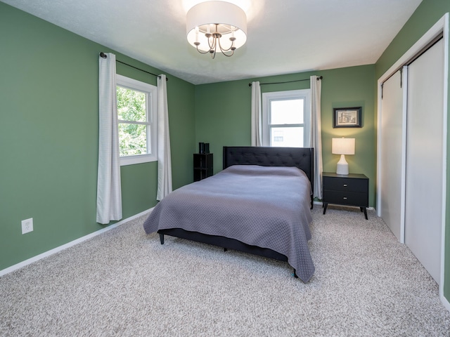 1627 Whitby Ave, Portage, MI 49024 - bedroom with carpet, a closet, and a chandelier