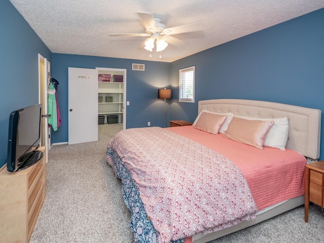 1627 Whitby Ave, Portage, MI 49024 - bedroom featuring carpet, a textured ceiling, ceiling fan, and a walk in closet