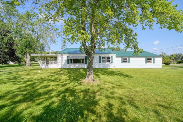 8020 Greenes Dr, Jackson, MI 49201 - rear view of property featuring a yard, a sunroom, and a metal roof