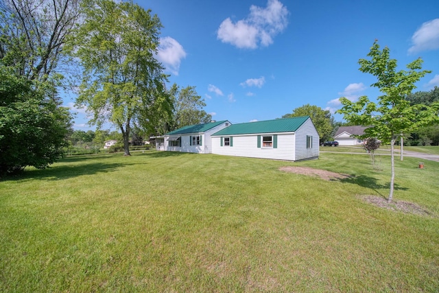 8020 Greenes Dr, Jackson, MI 49201 - back of house with a lawn and a metal roof