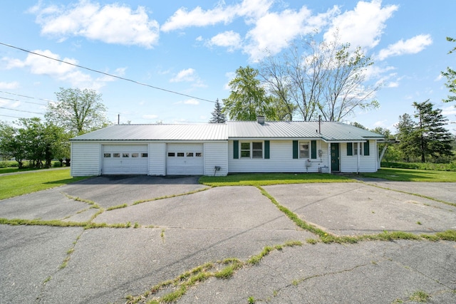 8020 Greenes Dr, Jackson, MI 49201 - ranch-style home featuring a front yard, a metal roof, a chimney, and asphalt driveway