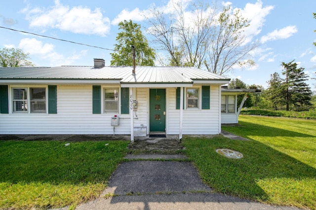8020 Greenes Dr, Jackson, MI 49201 - single story home with a front lawn, a metal roof, and a chimney