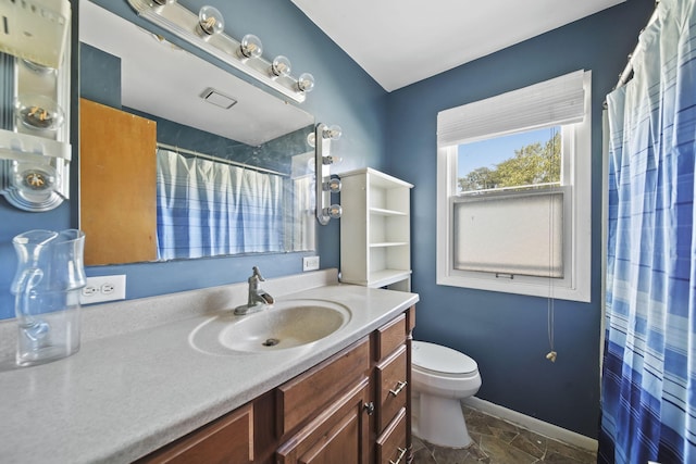 8020 Greenes Dr, Jackson, MI 49201 - bathroom featuring vanity, a shower with shower curtain, and stone finish flooring