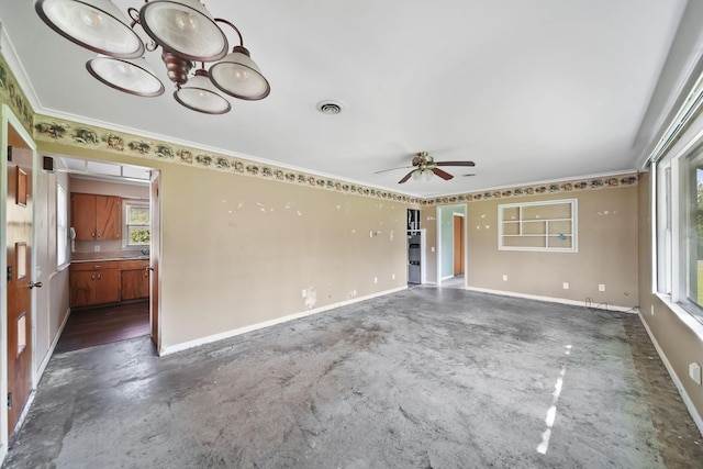 8020 Greenes Dr, Jackson, MI 49201 - spare room featuring a ceiling fan, a chandelier, ornamental molding, and concrete floors