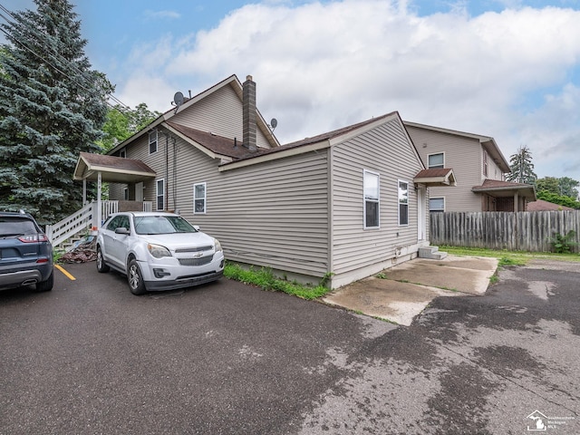 926 E Front St, Monroe, MI 48161 - view of property exterior with a chimney