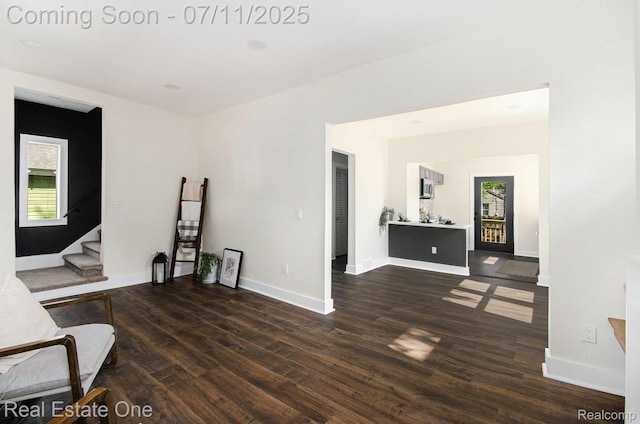 271 College St, Southfield, MI 48220 - living area featuring dark wood-style floors, stairs, and healthy amount of natural light