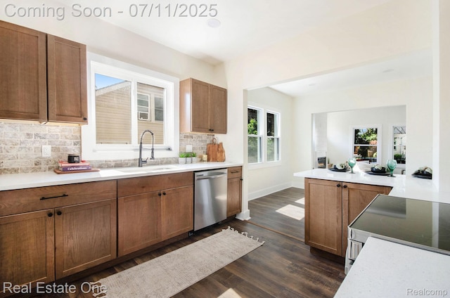 271 College St, Southfield, MI 48220 - kitchen featuring stainless steel appliances, dark wood-type flooring, tasteful backsplash, and brown cabinetry