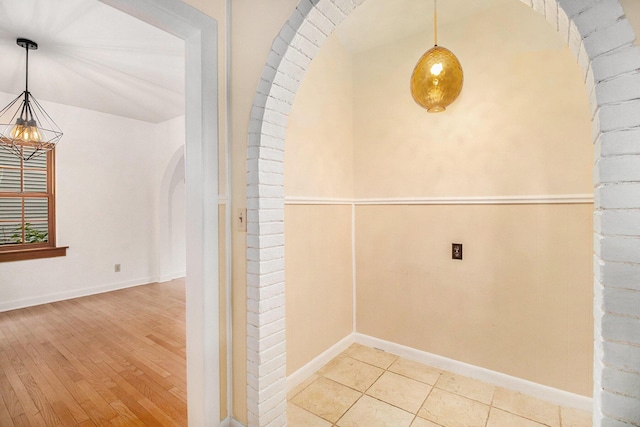 838 Lakeway Ave, Kalamazoo, MI 49001 - hall featuring arched walkways, wood finished floors, and a chandelier