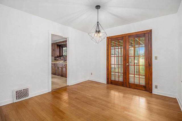 838 Lakeway Ave, Kalamazoo, MI 49001 - unfurnished room featuring french doors and light wood finished floors