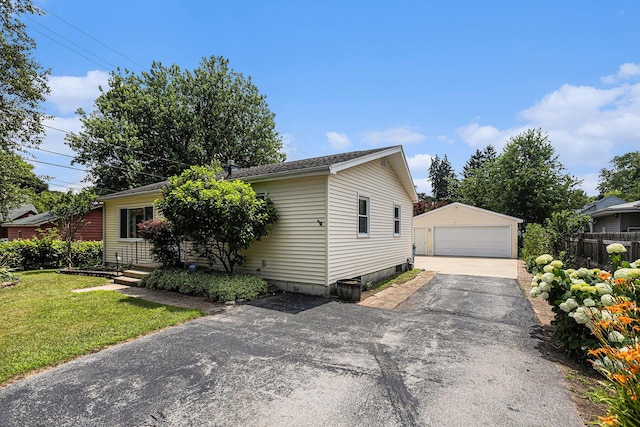 1109 Goguac St W, Battle Creek, MI 49015 - view of front facade featuring a detached garage and an outdoor structure