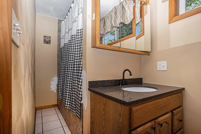 1109 Goguac St W, Battle Creek, MI 49015 - bathroom featuring vanity, curtained shower, and tile patterned floors