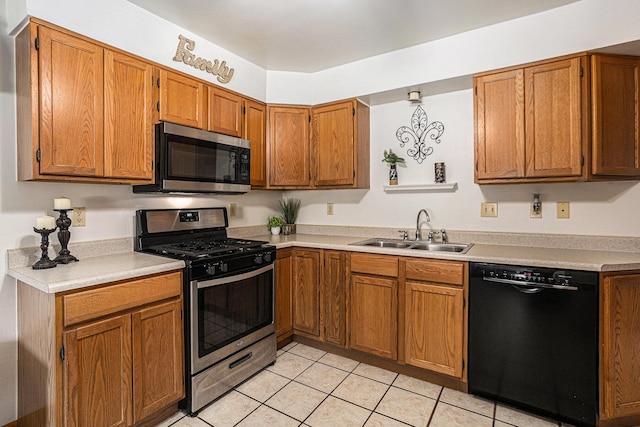 1109 Goguac St W, Battle Creek, MI 49015 - kitchen featuring appliances with stainless steel finishes, light countertops, light tile patterned flooring, and brown cabinets
