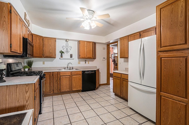 1109 Goguac St W, Battle Creek, MI 49015 - kitchen with black appliances, brown cabinetry, and light countertops