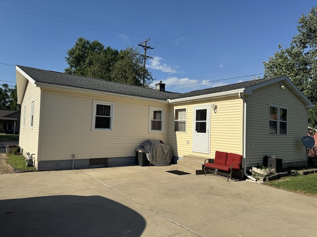 1109 Goguac St W, Battle Creek, MI 49015 - rear view of property with entry steps and a patio
