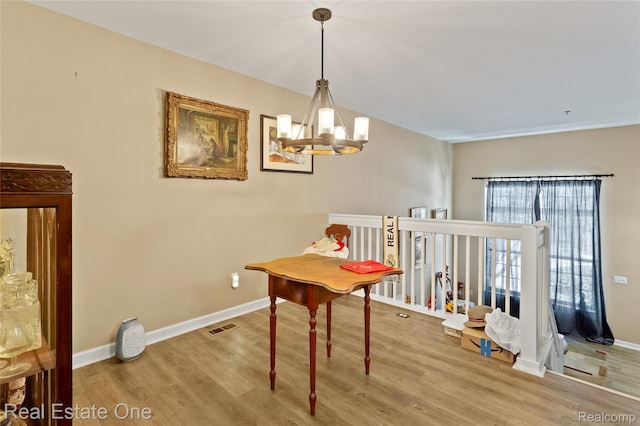 22145 W Village Dr, Dearborn, MI 48124 - dining space featuring wood finished floors and a chandelier