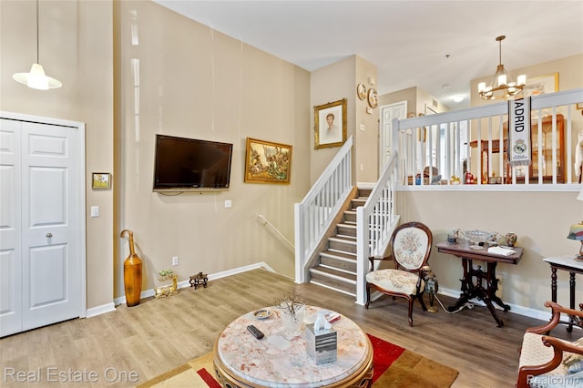 22145 W Village Dr, Dearborn, MI 48124 - living area featuring a chandelier, wood finished floors, and stairway