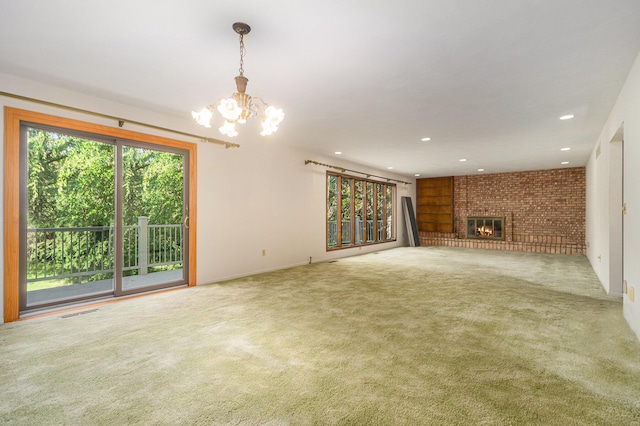 45745 County Road 652, Mattawan, MI 49071 - unfurnished living room featuring a chandelier, carpet, brick wall, a brick fireplace, and recessed lighting