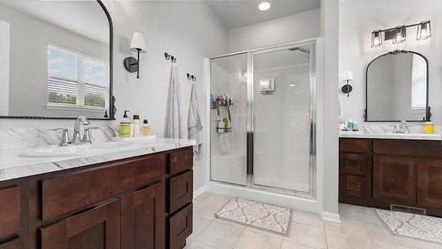 3850 Diuble Rd, Ann Arbor, MI 48103 - bathroom featuring a stall shower, two vanities, and tile patterned floors