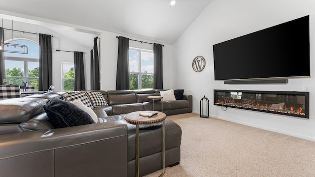 3850 Diuble Rd, Ann Arbor, MI 48103 - living room with light colored carpet, a glass covered fireplace, and high vaulted ceiling