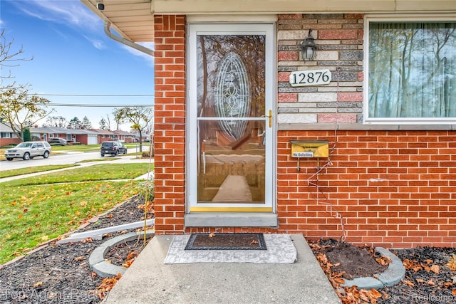 12876 Martin Rd, Warren, MI 48088 - doorway to property with brick siding and a yard