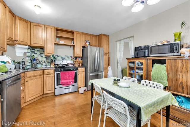 12876 Martin Rd, Warren, MI 48088 - kitchen featuring appliances with stainless steel finishes, light wood-type flooring, backsplash, stone countertops, and open shelves