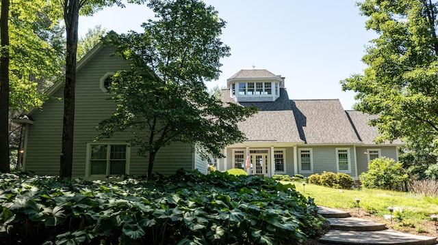 4569 N Ridge Rd, Mears, MI 49436 - view of front of property featuring a shingled roof and french doors