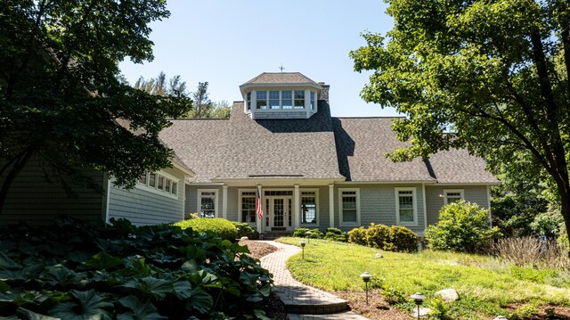 4569 N Ridge Rd, Mears, MI 49436 - view of front of property featuring roof with shingles, a front lawn, and french doors