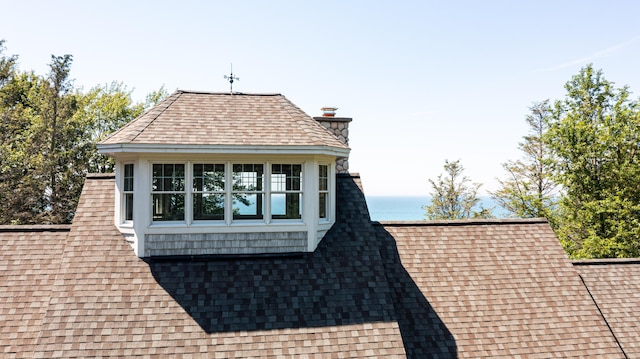 4569 N Ridge Rd, Mears, MI 49436 - view of home's exterior featuring roof with shingles