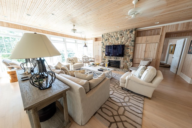 4569 N Ridge Rd, Mears, MI 49436 - living room featuring plenty of natural light, wood ceiling, light wood finished floors, and wooden walls