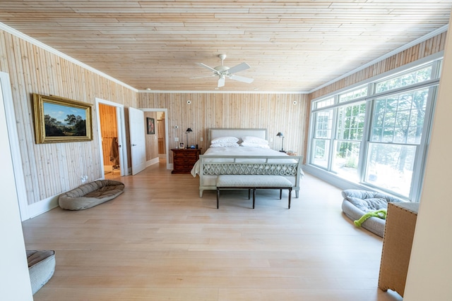 4569 N Ridge Rd, Mears, MI 49436 - bedroom with multiple windows, wooden walls, wooden ceiling, wood finished floors, and ceiling fan