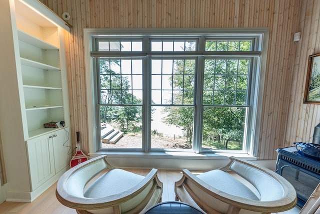 4569 N Ridge Rd, Mears, MI 49436 - bathroom with wood walls, plenty of natural light, a wood stove, and wood finished floors