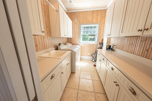 4569 N Ridge Rd, Mears, MI 49436 - laundry area featuring cabinet space, stone tile flooring, independent washer and dryer, and wood walls