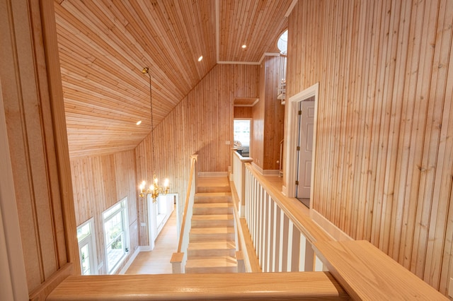 4569 N Ridge Rd, Mears, MI 49436 - stairway featuring wood ceiling, wooden walls, lofted ceiling, a chandelier, and plenty of natural light