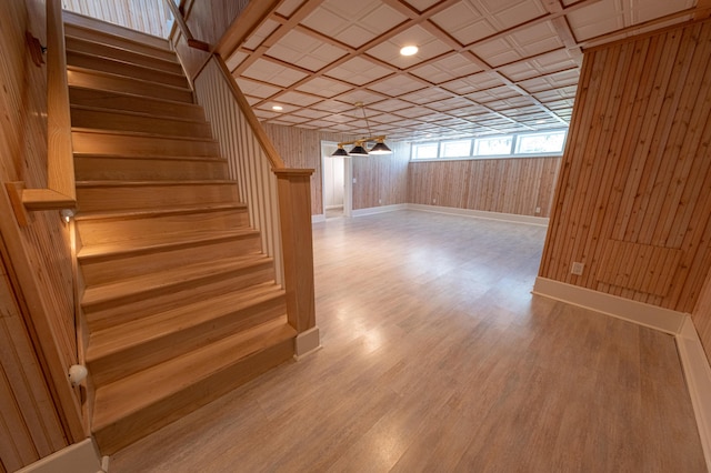 4569 N Ridge Rd, Mears, MI 49436 - staircase featuring wooden walls and wood finished floors