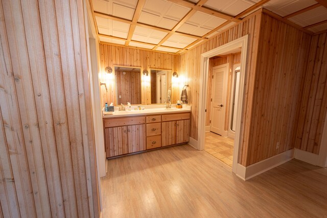 4569 N Ridge Rd, Mears, MI 49436 - bathroom with double vanity, wood finished floors, and wood walls
